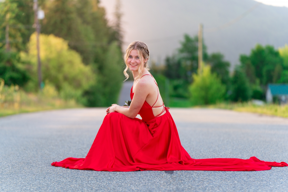 A female teen poses for formal portraits in a red gown in Salmon Arm BC